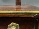 a close up of a wooden table with a clock on it