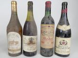 several bottles of wine are lined up on a white surface
