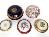 several different types of decorative boxes sitting on top of a white surface