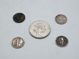 a close up of a coin and several other coins on a table