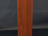 a wooden pedestal with a marble top and a black base
