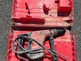 a red box with a drill and a cord in it