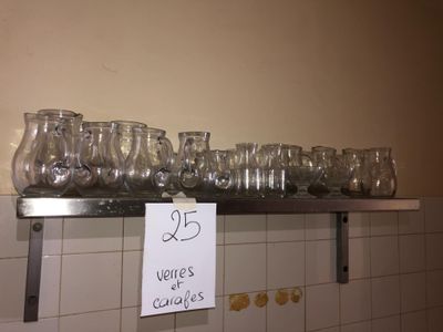 many glasses on a shelf with a price tag on it