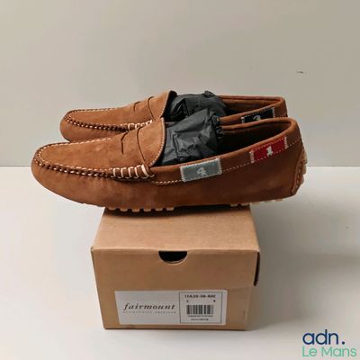 des chaussures de conduite pour homme, de couleur beige, posées sur une boîte en carton
