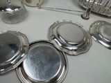 many silver dishes and silverware on the table