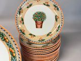many plates with oranges on them sitting on a table