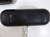 a black cell phone that is connected to a charger