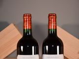 two bottles of wine sitting next to each other on a table