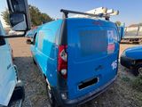 a blue van that is parked in a lot