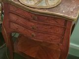 a table with a lamp on top of it in a room