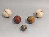 several different types of marble balls on a white surface