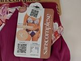pink panties with a tag attached to them sitting on a table