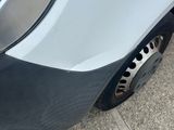 a close up of a car ' s front bumper and tire