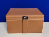 a tan leather box with a lock on top of it