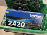 a green basket filled with wires and a black box