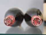 two bottles of wine sitting on a glass table