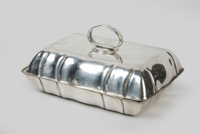 silver plated butter dish with a ring on top of it
