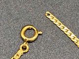 a close up of a chain and a bracelet on a table