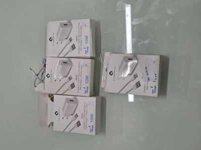 three boxes of the same type of charger are sitting on a glass surface