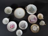 many cups and saucers sitting on a black table