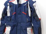 jacket on a hanger in a room with a white wall