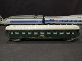 two toy trains are sitting side by side on a black surface