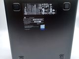 the back of a laptop with a battery on it sitting on a white surface