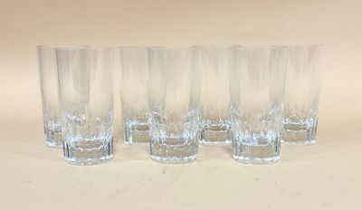 quatre verres transparents sont alignés sur une surface blanche