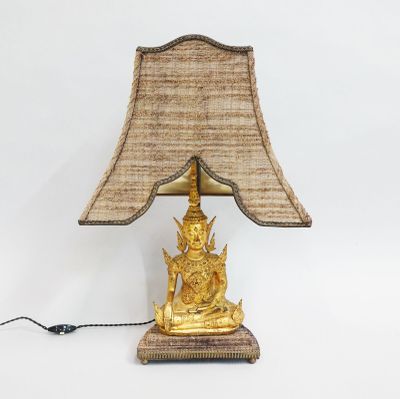 an image of a golden buddha lamp on a white background