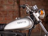 a motorcycle parked in a garage with a brick wall in the background