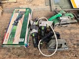 a box of tools sitting on a table next to a corded saw