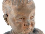 statue of a baby with a collar on a white background