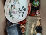 a cardboard box filled with assorted items including a plate