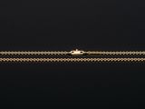 a gold chain bracelet with a clasp on a black background
