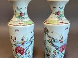 pair of chinese vases with birds and flowers painted on them