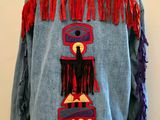 denim jacket with red fringes on a mannequin stand