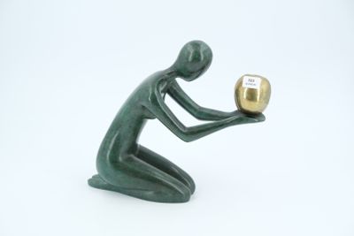 a figurine of a man holding a golden object