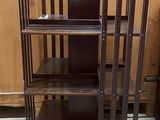 a wooden bookcase with three shelves on it in a room