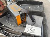 a suitcase that has a welding machine inside of it