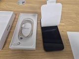a box with a phone and a charger on the table