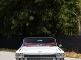 a white car that is parked on the side of the road