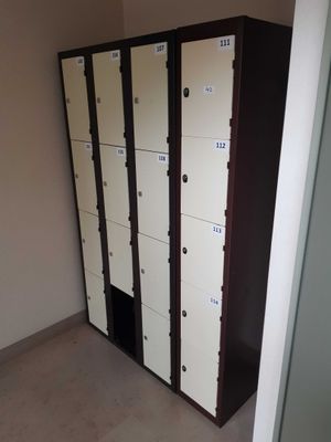 many lockers in a room with a lot of doors