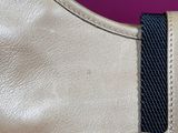 leather handbag with a black and white stripe on a pink background