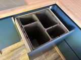 four bins in the bottom of a kitchen drawer