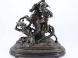 bronze statue of a man on a horse with a woman on a horse