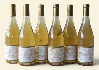 six bottles of wine are lined up in a row on a white surface