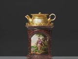 un vase avec un tableau posé sur une table