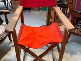 a red chair that is sitting in the middle of a room