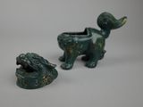 two figurines of a dog and a cat on a table