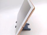 a tablet that is sitting on a stand on a table